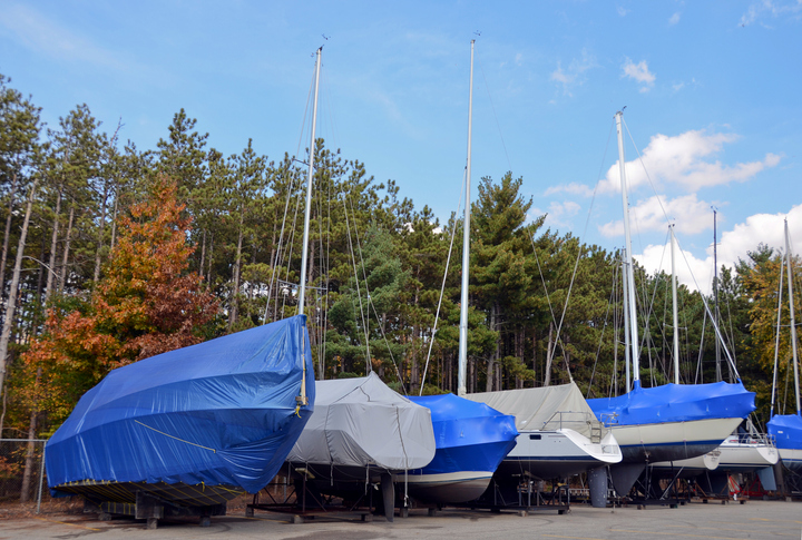 covered boats in outdoor storage